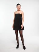 Black A-line silk dress by MOSAÏKA worn on model with relaxed pose