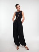 Black balloon trousers by MOSAÏKA styled with bodysuit standing pose