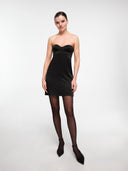 Black bustier mini dress by MOSAÏKA worn on model in natural pose